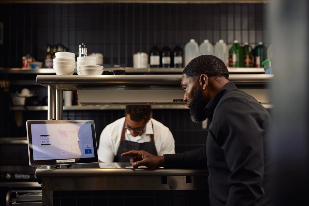 Restaurant owner at the pass while a chef works behind him, from a Chalant photo shoot